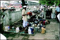 Stopping to catch their breath and get their second wind, the dabbawallas often do not have time for their own lunch... which is ironical, considering they are delivering meals to people.