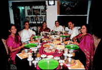 The A. S. Raja family sits down to a traditional and authentic coastal Andhra meal at home. Notice, they eat out of banana leaves placed in silver thalis!