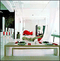 The interior of Green T. House with red-upholstered sofas.