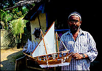 The Maliyekkal Gift Houses proprietor K. M. Mubarak with a model of a sailing boat. His shop stands incongrously among hardware establishments selling ship-building material at Beypore.
