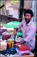 A halwa vendor along the highway prepares to cut a slice of the popular Calicut banana halwa.