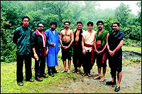 Sunil Kumar, bare-chested, with other Kalaripayattu fighters and Shah Rukh Khan on the sets of Asoka.