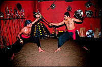 Sunil Kumar, right, the Kalaripayattu instructor in a sword fight with a student.