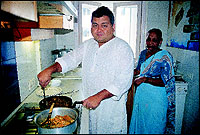 Kunal in his cosy little kitchen, cooking, naturally, while his treasured Maratha housekeeper Indu Rane looks on.