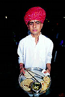 A waiter with his tray of breads, there is rotla, thepla, bhakri and phulka, and a wati of pure ghee!