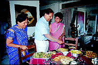 Kumudben, Praful and Shilpa share a light moment at the dining table at the start of their Surti meal.