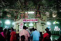 The sanctum sanctorum where the idol of the Sleeping Hanuman (below) is worshipped by millions from all over India.