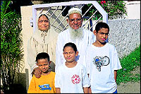 Shabbir Hussain Josh with his wife Sabeera and American grandchildren.