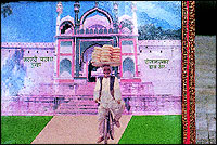 A picture of Taufiq Ahmeds father cycling from his village to Khuldabad balancing a tray of Khaja on his head.
