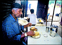 An early morning diner enjoys his Paya-Roti at the Islami Hotel. Top, the dekchi of Shirwa. Middle, the Unani flavouring agent dagad-phool. Bottom, the Roti that is flavoured with saunf and kalonji.