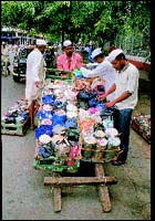 Dabbawallas outside Churchgate Station in Bombay prepare themselves for the last stretch of their relay race to get lunch to office-goers in time.