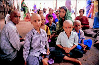 Families of pilgrims with heads tonsured to appease Lord Narasimha, collect their prasad and then sit down in a large enclosure to consume it.