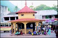 Pilgrims waiting at a bus-stand for buses that will take them to the temple from the foothill.