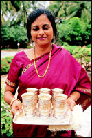 Dr. A. Sugandhi welcomes visitors with a cooling drink.