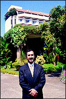 General Manager Raman Kaul and the Taj Residency at Calicut behind him.