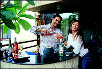 Arbaaz and Malaika are complete foodies. Their lives revolve around food. Here he is pouring himself a drink at their terrace bar. She doesnt drink nor smoke. These little things make a difference, she says.