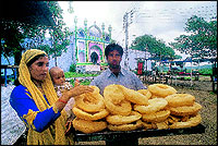 Taufiq Ahmed and Munawar Begum selling Khaja outside the Rauza that is Emperor Aurangzebs tomb in Khuldabad.