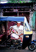 And a Muslim autowallah catches up on the news while waiting for passengers.