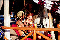 A tourist couple share a drink.