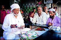 Sharfubhai gets behind 
the counter very often to make pans for his favourite customers and for the TV cameras.