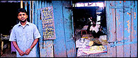Anees Khan, the proprietors son, outside the Islami Hotel. Through the window, you can see a man sitting at the tandoor and turning out the Rotis for Paya.