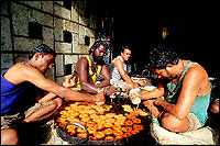 The karigars at work on four 
bhattis that make Imartis and Jalebis at the Uttam Uphar Graha.
